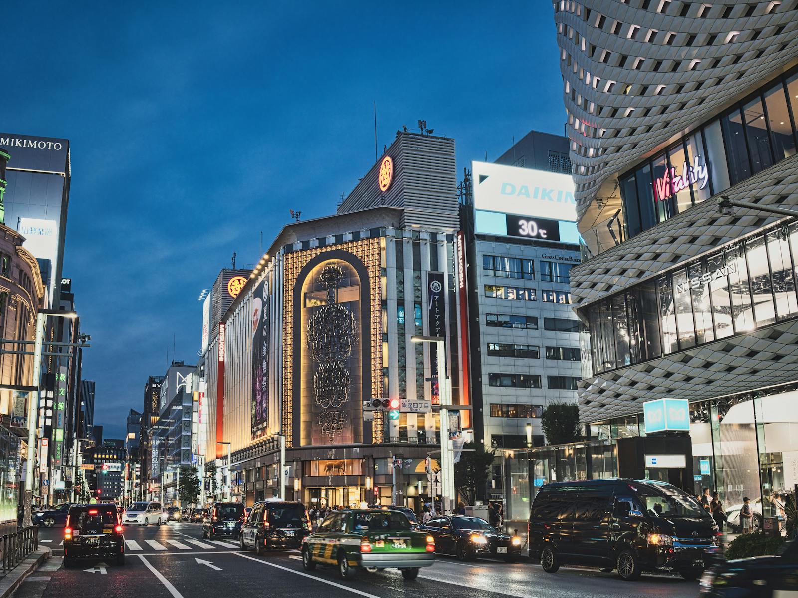 Elegant Ginza district in Tokyo at evening with illuminated luxury storefronts and wide boulevards