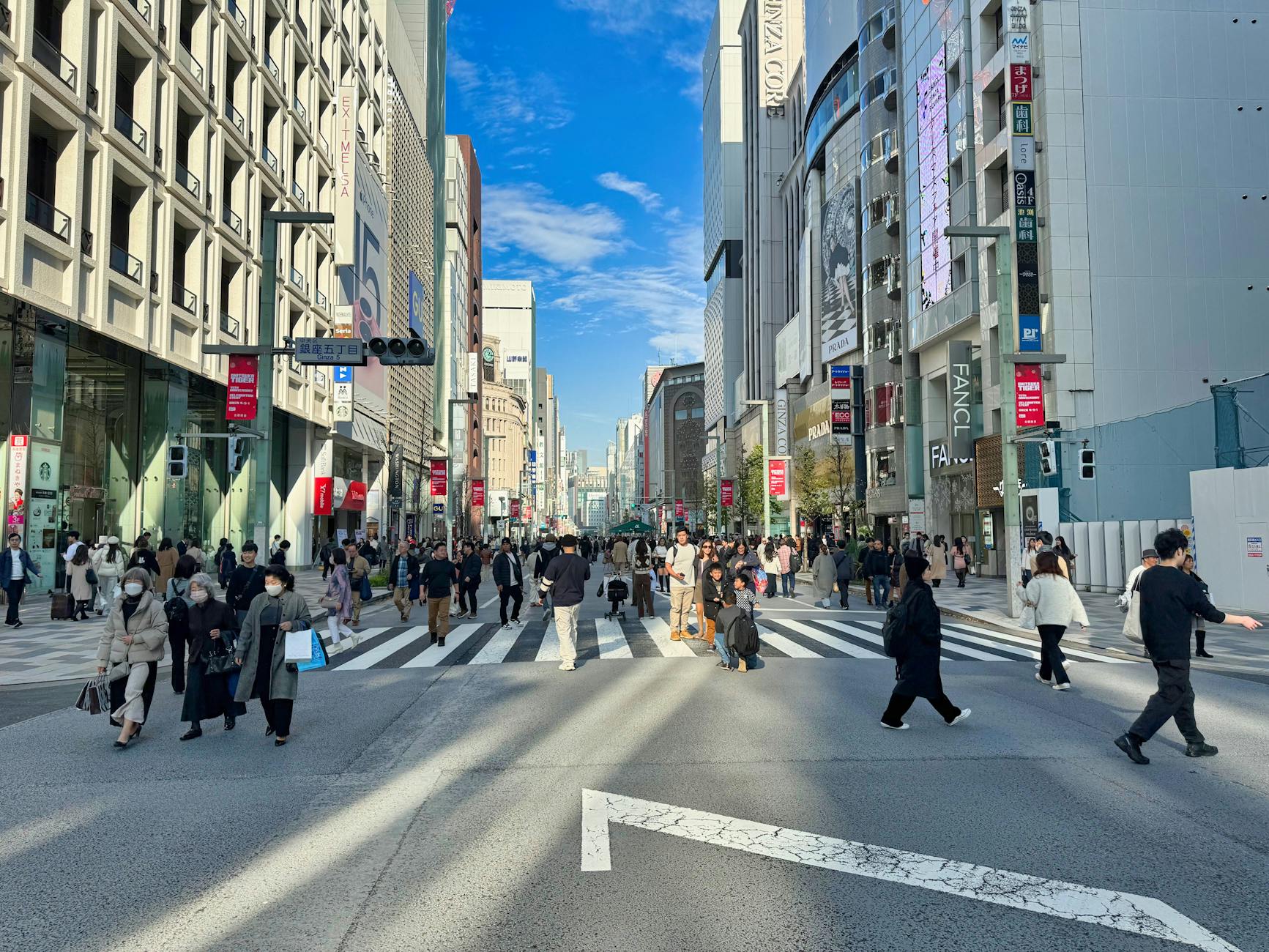 Ginza shopping street in Tokyo at dusk with luxury brand stores and illuminated signs - tokyo shopping guide