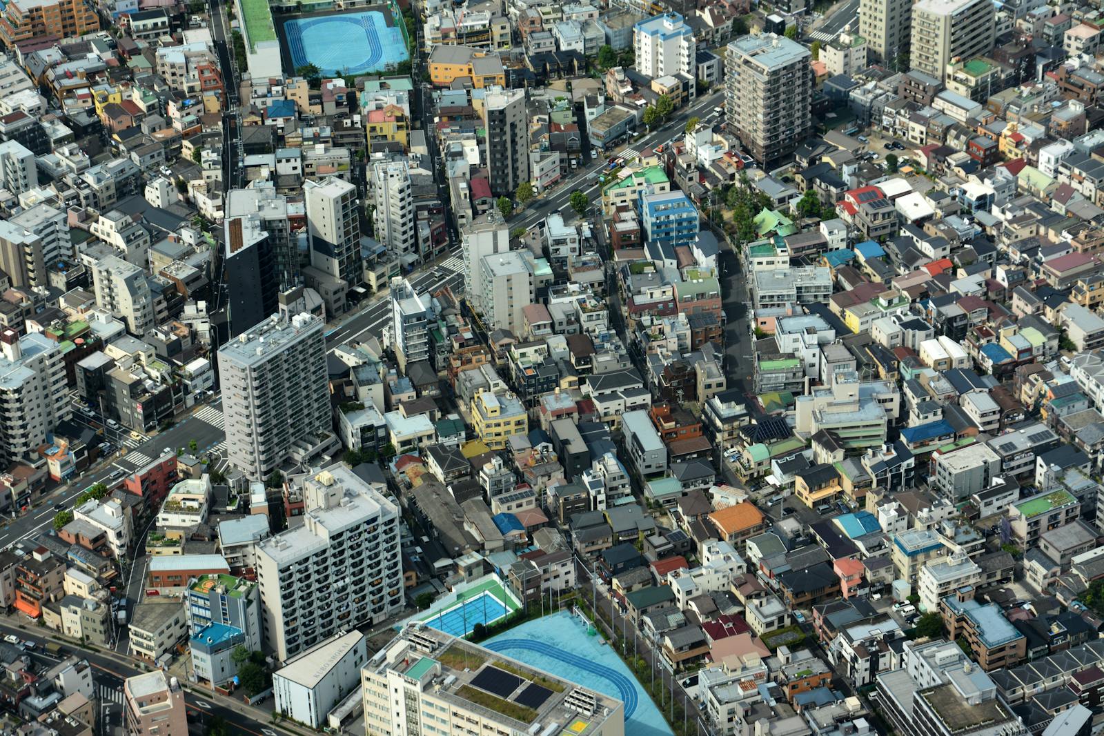 Aerial view of Tokyo neighborhoods showing the dense urban landscape of distinct districts