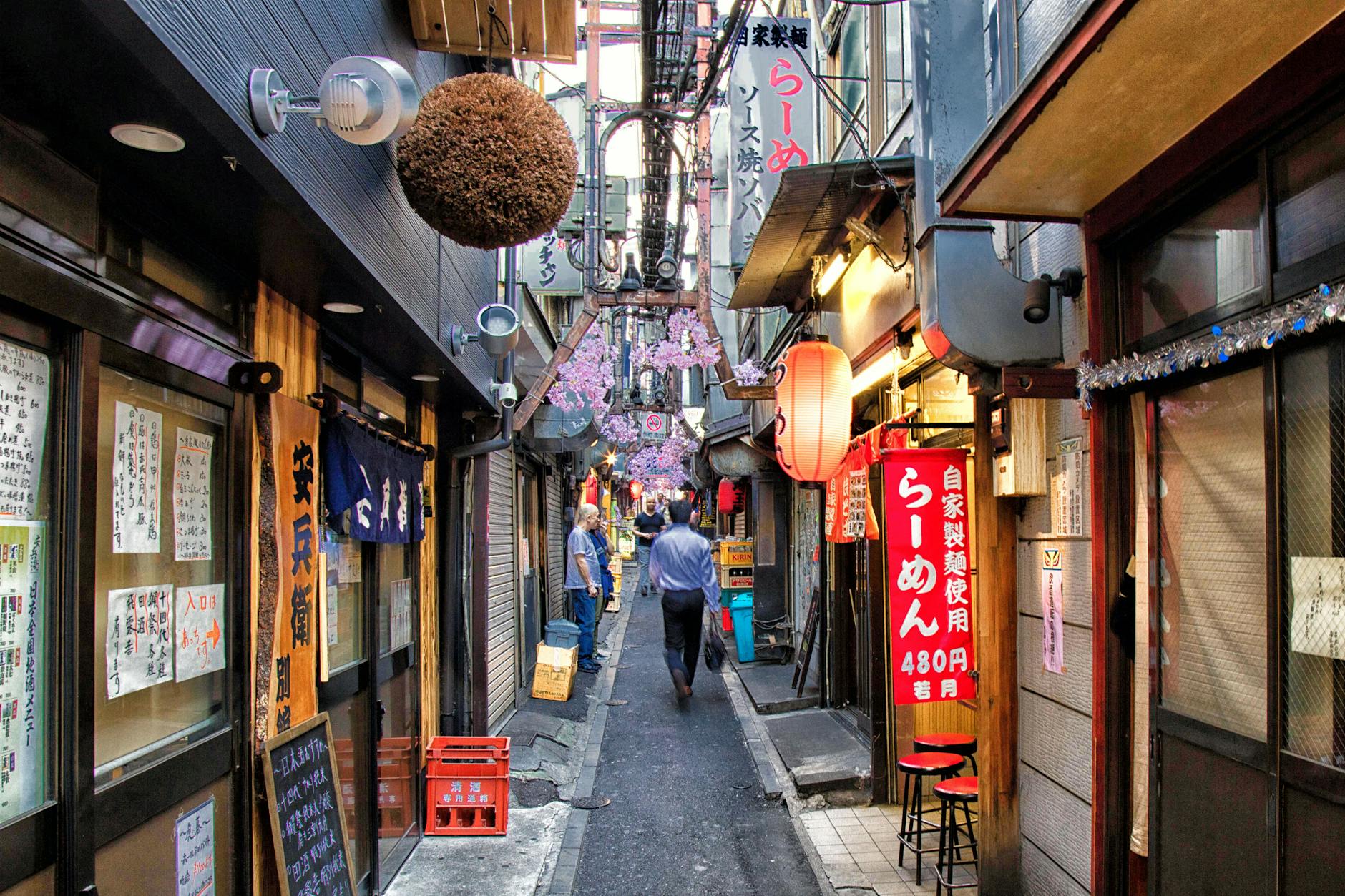 Atmospheric narrow restaurant alley in Tokyo illuminated at night