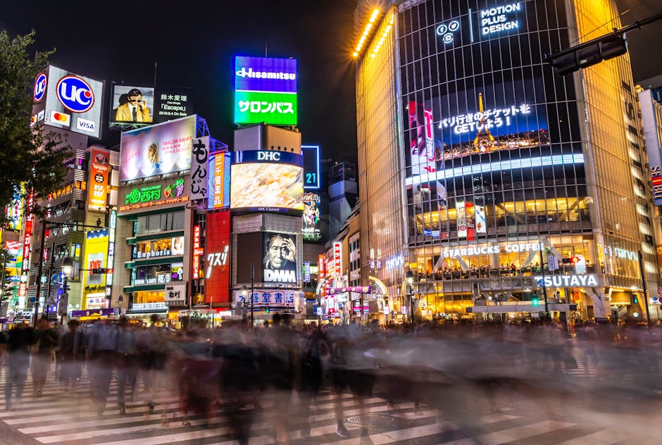 Shibuya district at night with neon signs and crowds