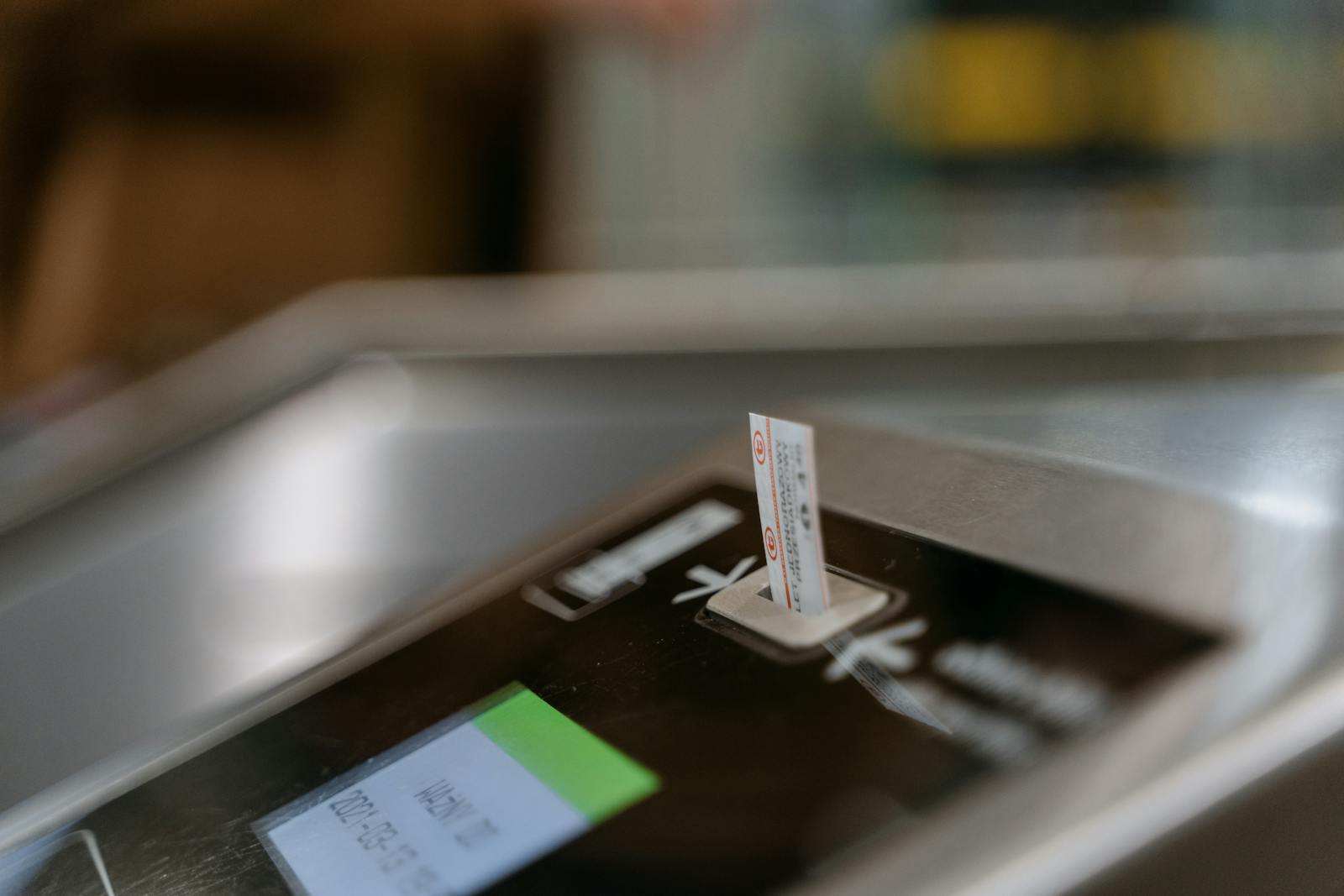 Close-up of a Tokyo subway ticket machine with a ticket being purchased