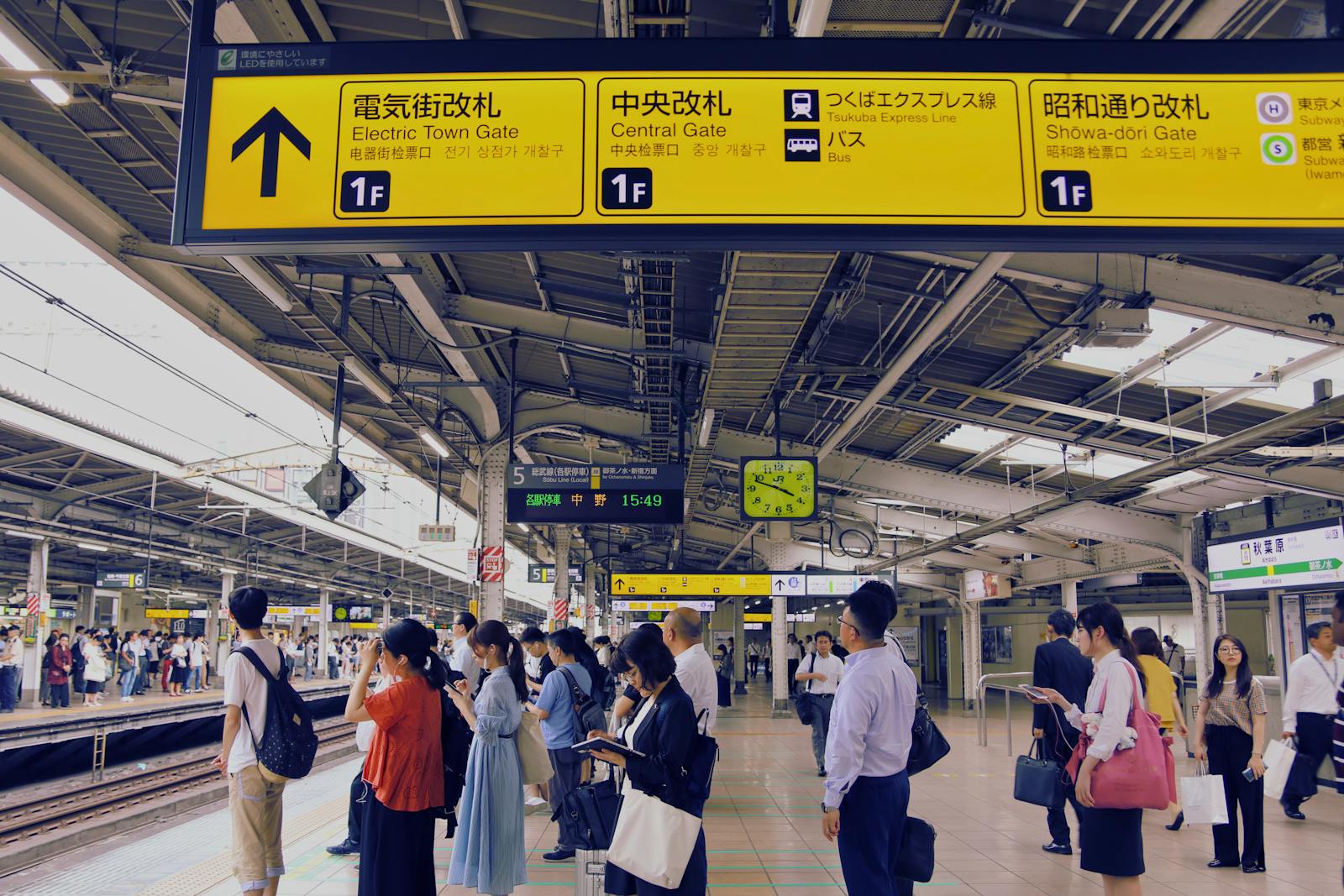 Commuters waiting on a busy Tokyo train station platform during rush hour