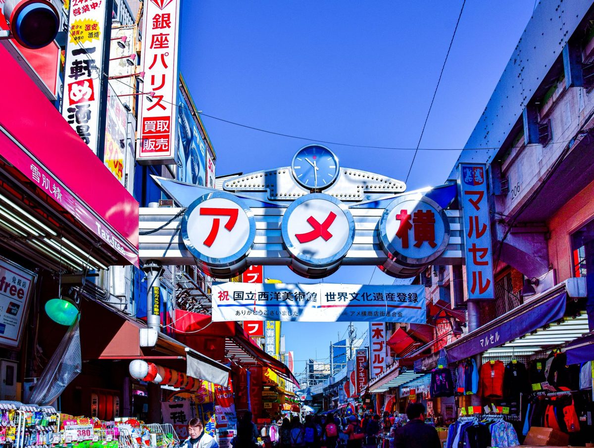 Crowds and signs in the Ameyoko market street near Ueno
