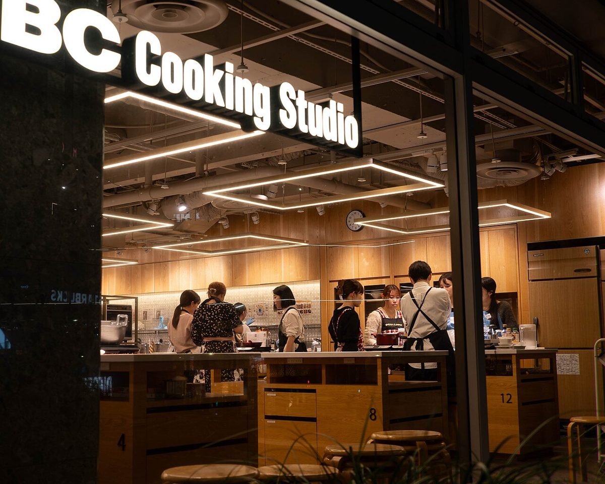 Participants preparing Japanese dishes together in a cooking class