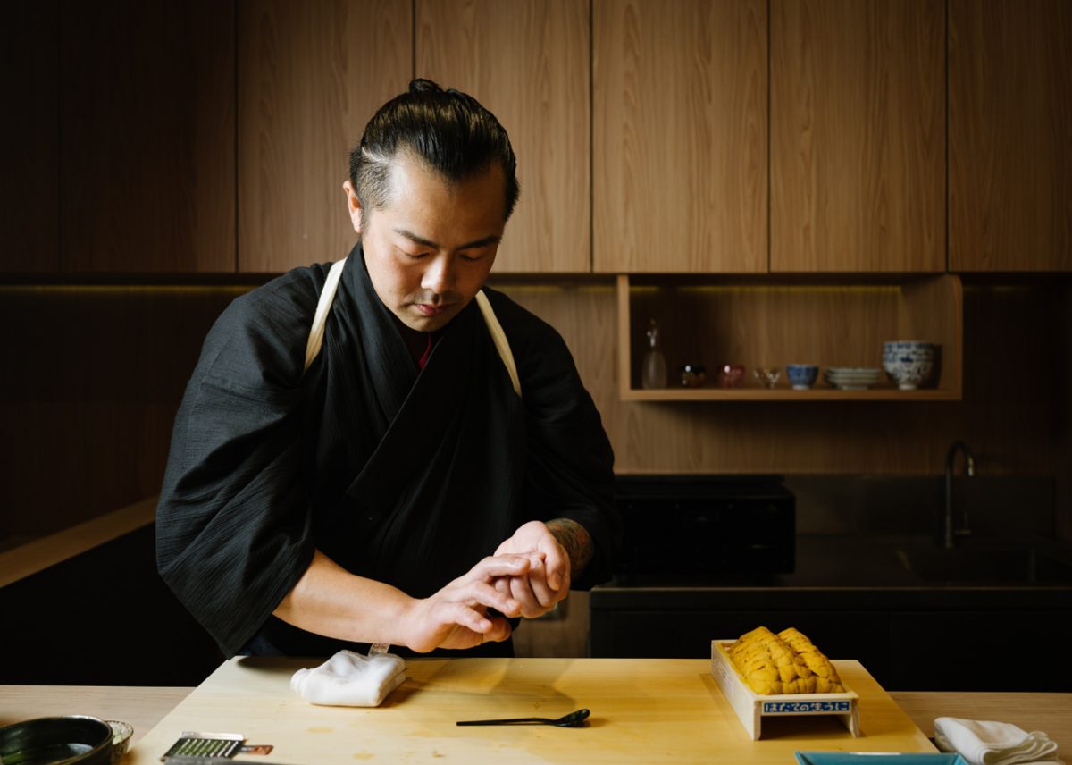 Hands shaping nigiri sushi at a cooking class