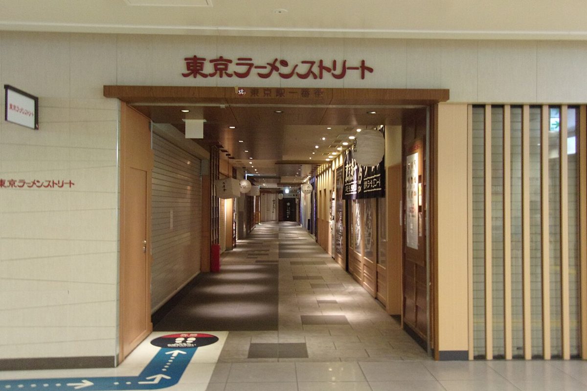 Bustling indoor shopping and food arcade beneath a Tokyo station
