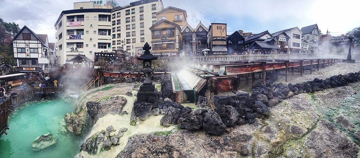 The Yubatake hot water field glowing at night in Kusatsu Onsen town