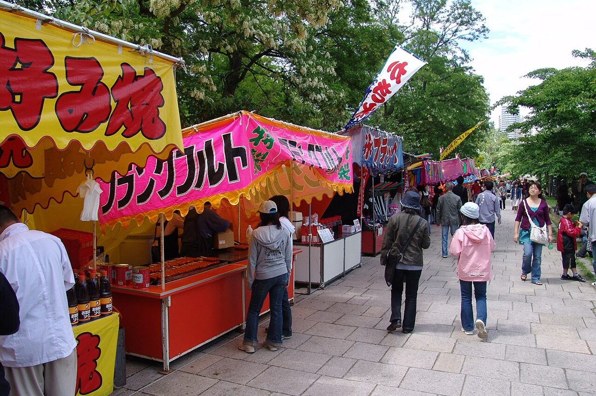 Festival food stalls lit up at night at a Japanese matsuri