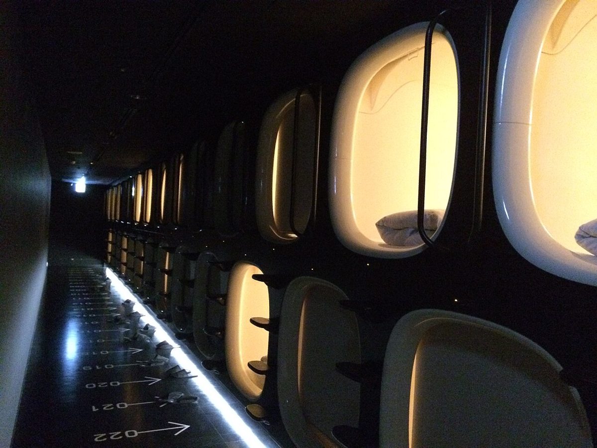 White futuristic sleeping pods at a Nine Hours capsule hotel