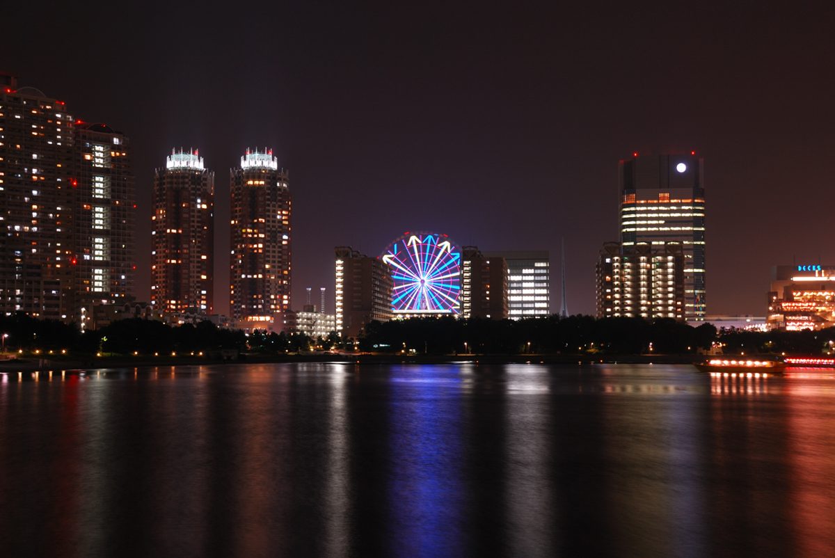 Odaiba and the Rainbow Bridge lit up at night with the Tokyo skyline