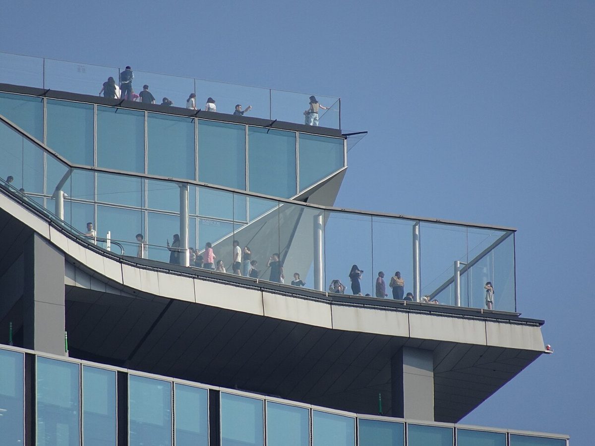 Visitors on the open-air rooftop of Shibuya Sky looking out over the Tokyo skyline