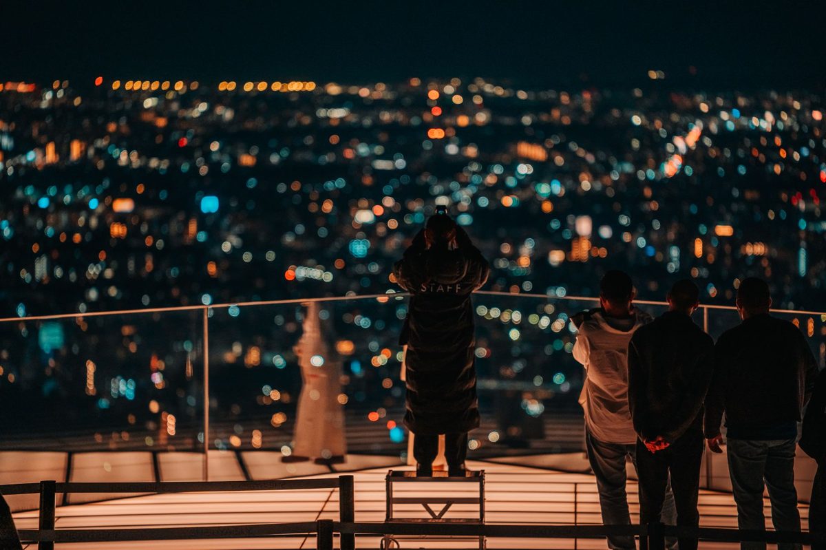 The view over Tokyo from a high rooftop observation deck at dusk