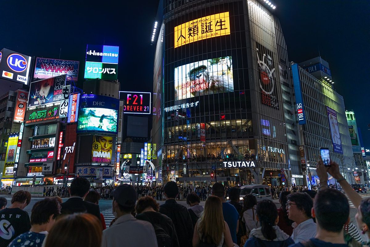 Using a smartphone on a Tokyo street at night