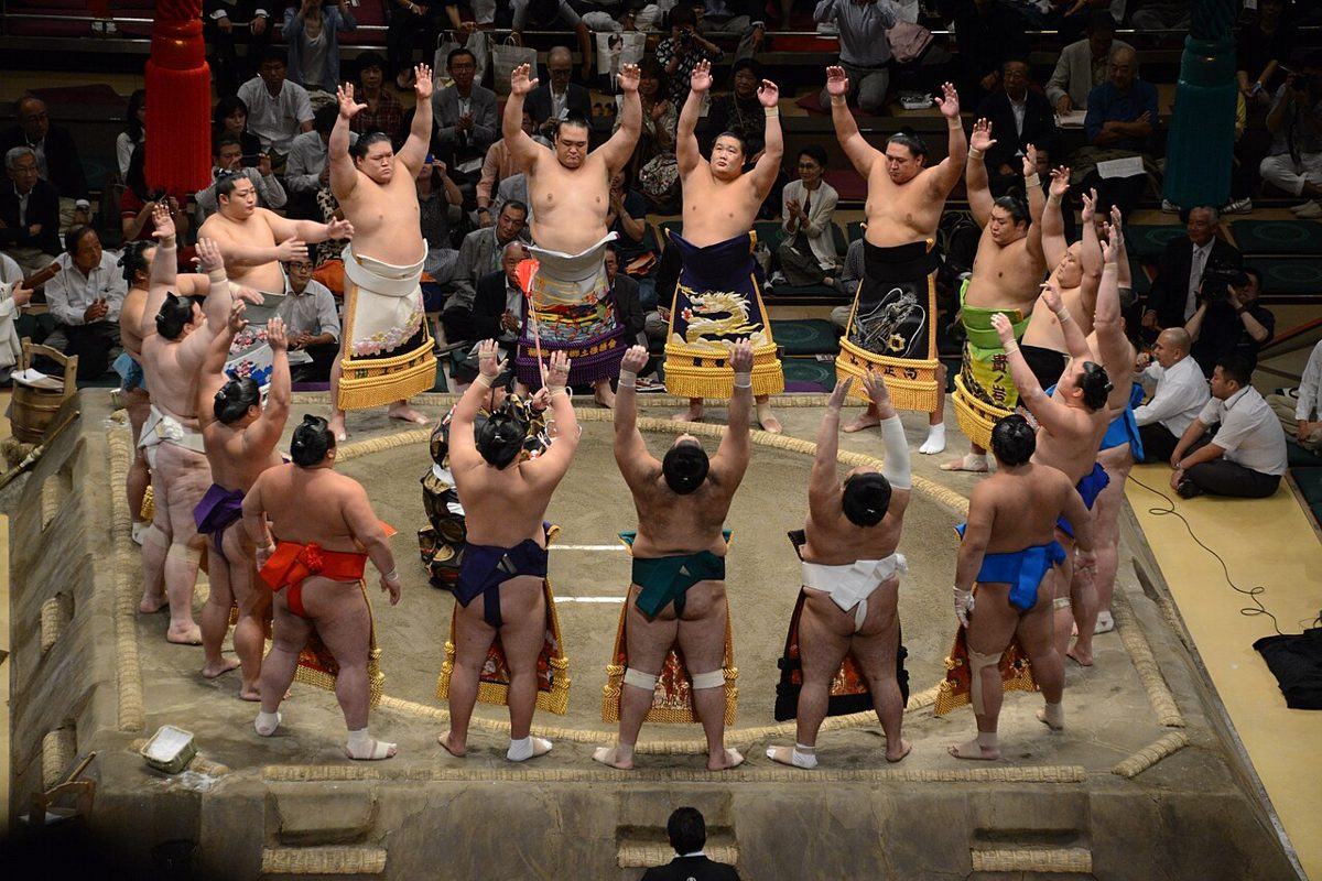 Sumo wrestlers in ceremonial aprons during the dohyo-iri ring-entering ceremony