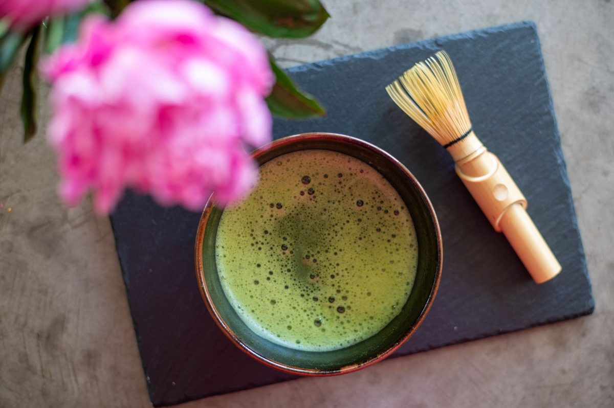 A bowl of matcha with digital flowers blooming inside it at the EN Tea House