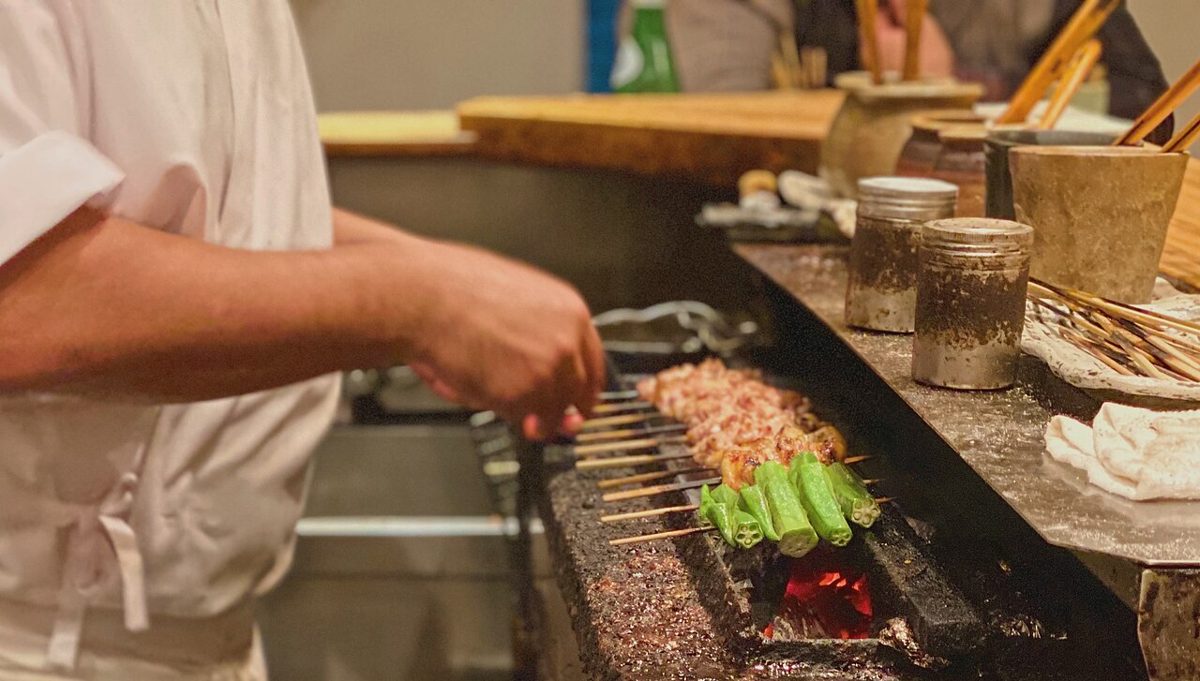 Close-up of grilled chicken skewers brushed with tare sauce