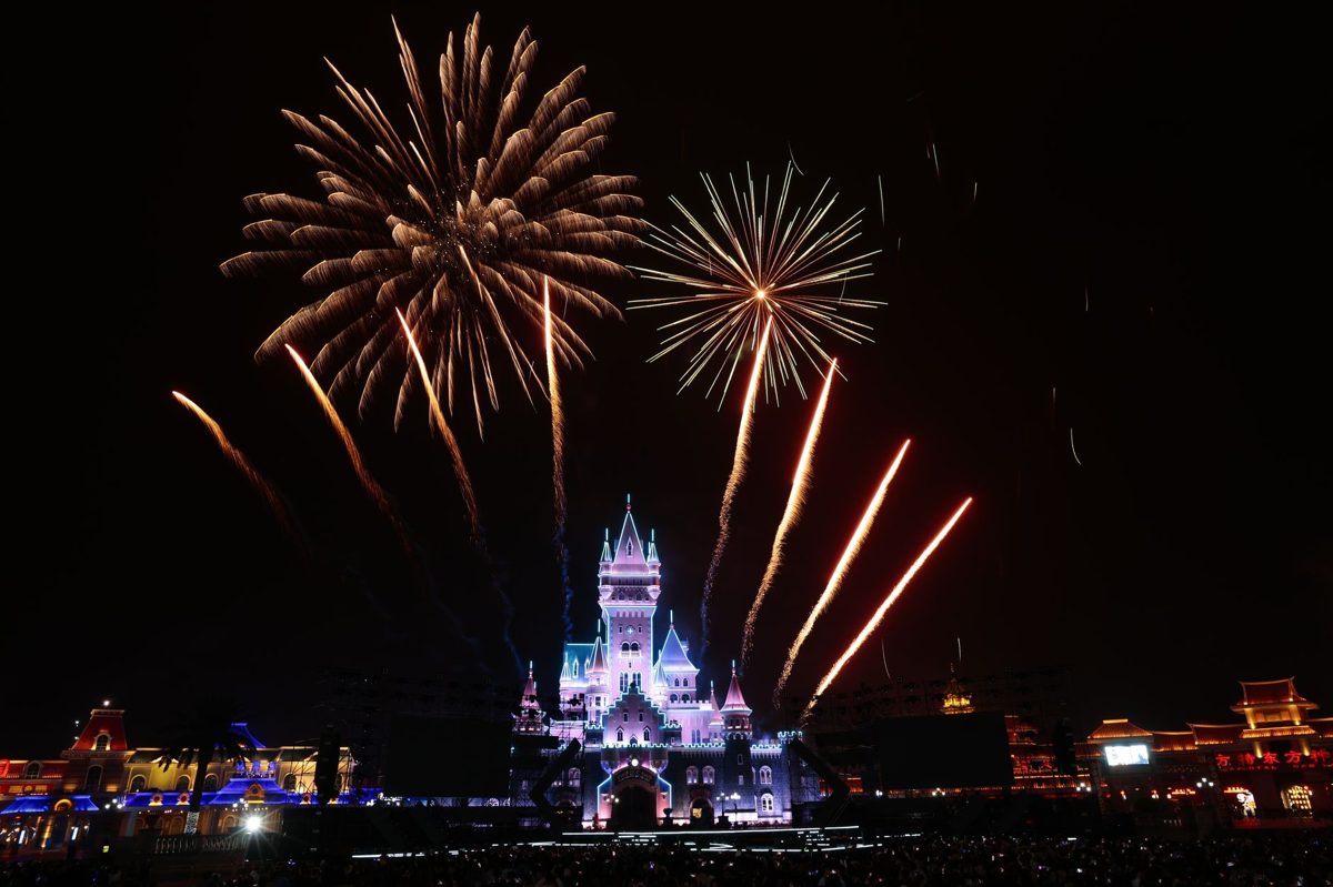 Fireworks bursting over a Disney castle at night