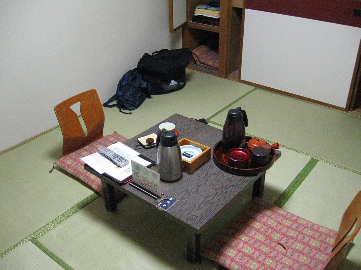 Traditional tatami-mat room with futon bedding in a Japanese guesthouse