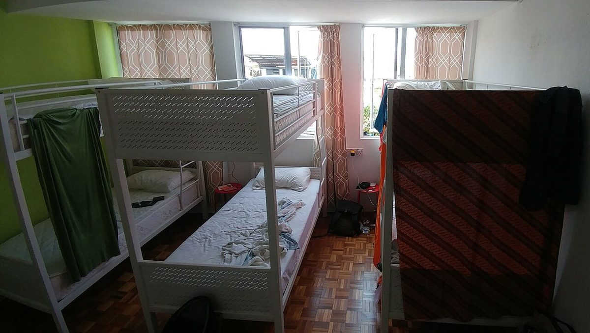 Wooden bunk beds in a Tokyo hostel dormitory room