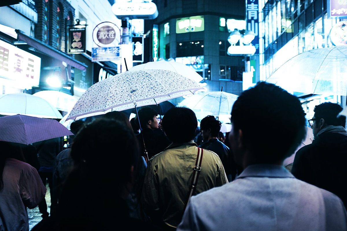 People with umbrellas on a rainy Tokyo street