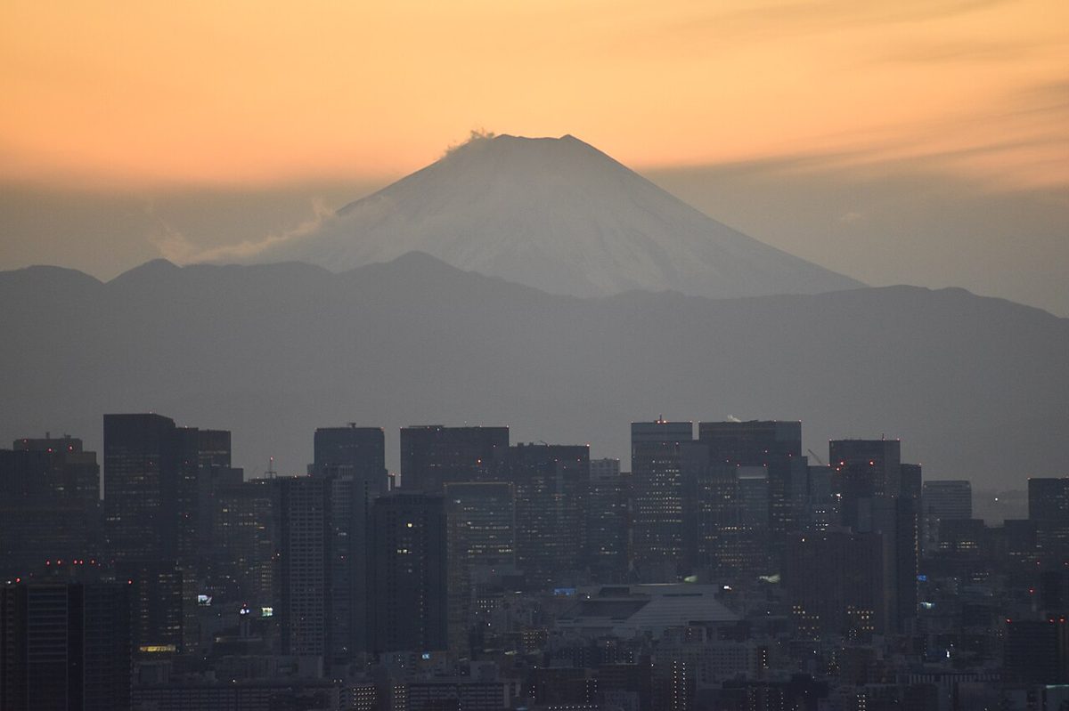 Tokyo skyline at sunset with Mount Fuji on the horizon