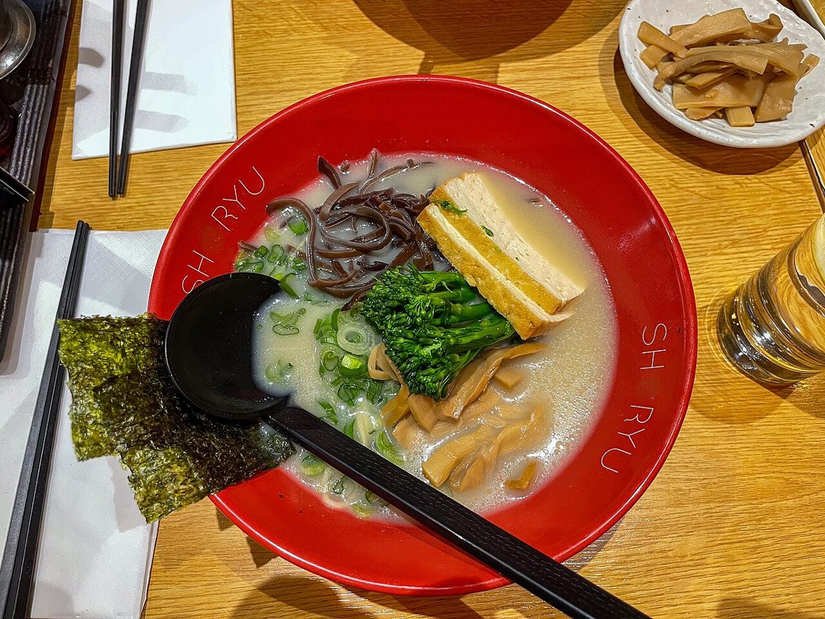 A bowl of plant-based vegan ramen topped with vegetables