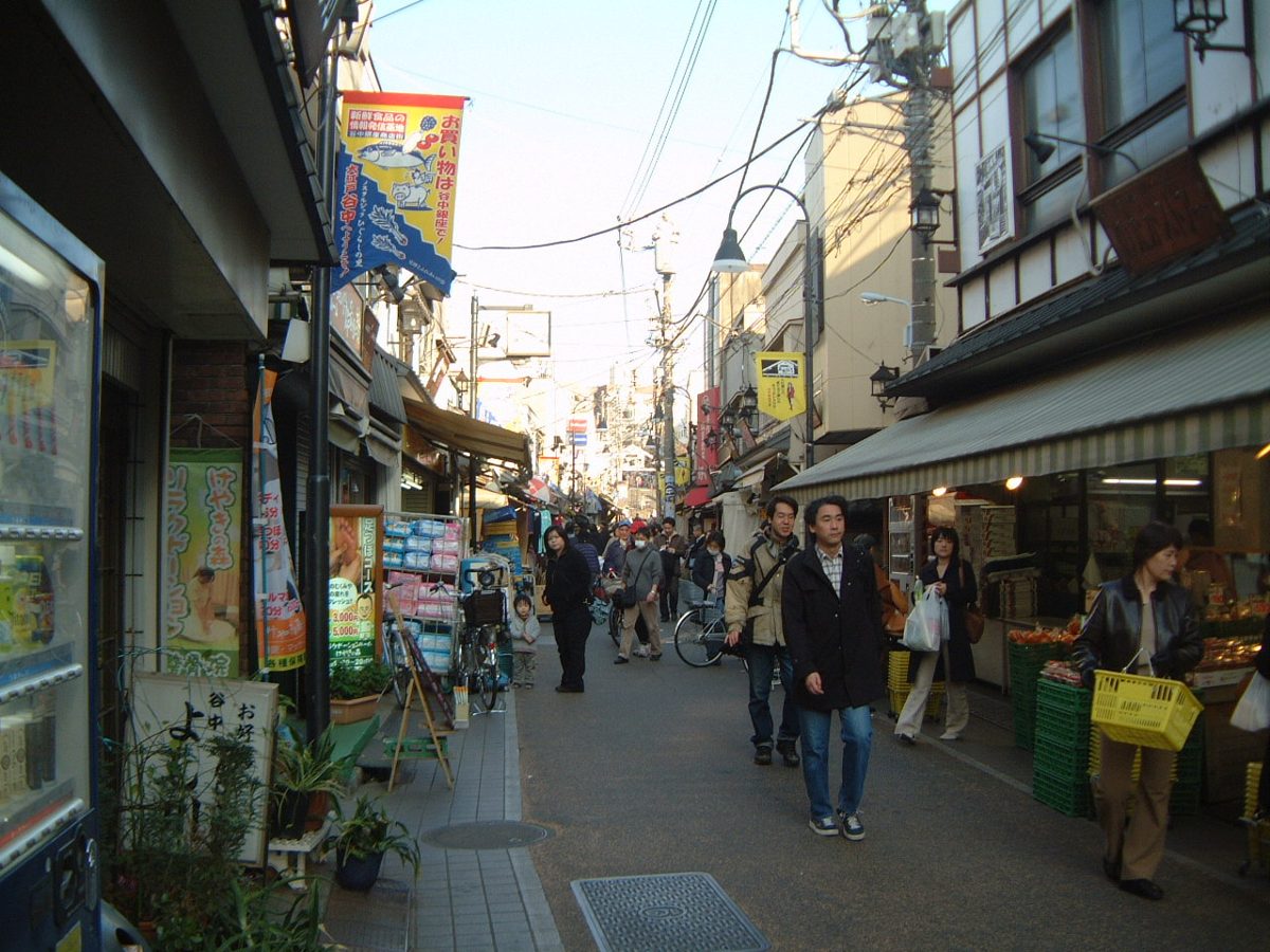 A quiet old street with traditional wooden buildings in Yanaka, Tokyo