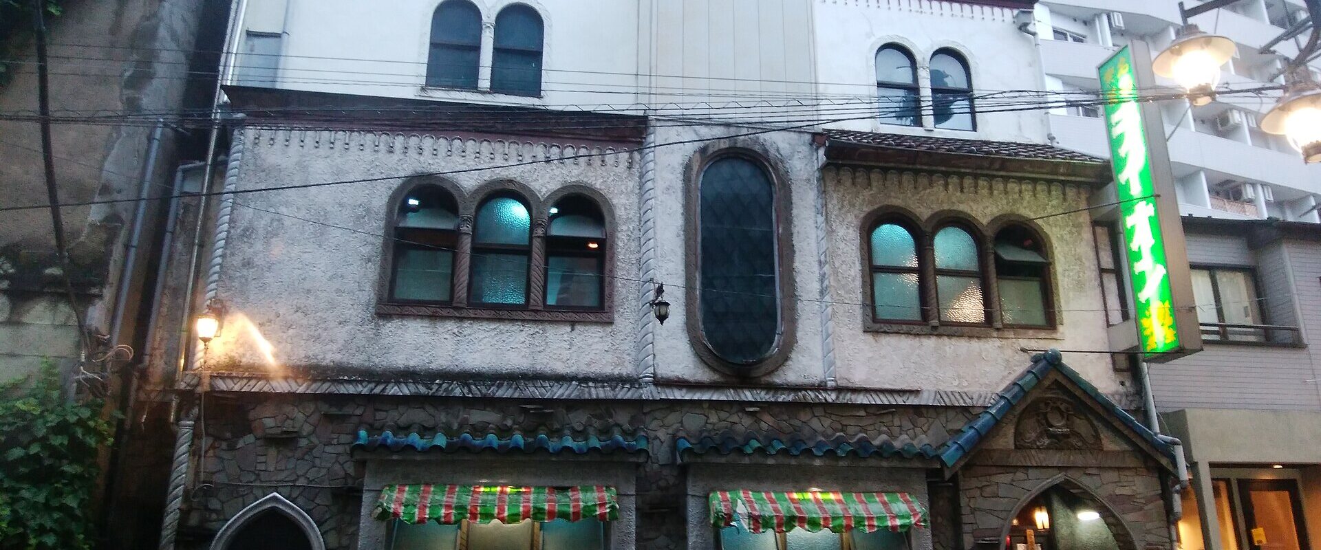 The ornate stone and stucco facade of Meikyoku Kissa Lion, a classical music coffee house in Shibuya