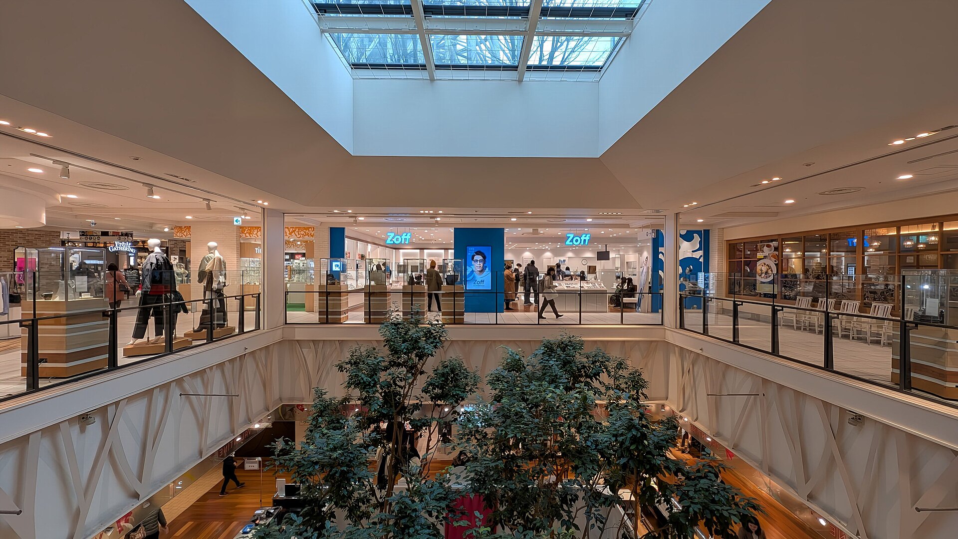 A multi-level indoor atrium in Tokyo Solamachi shopping centre with shops around a planted central well