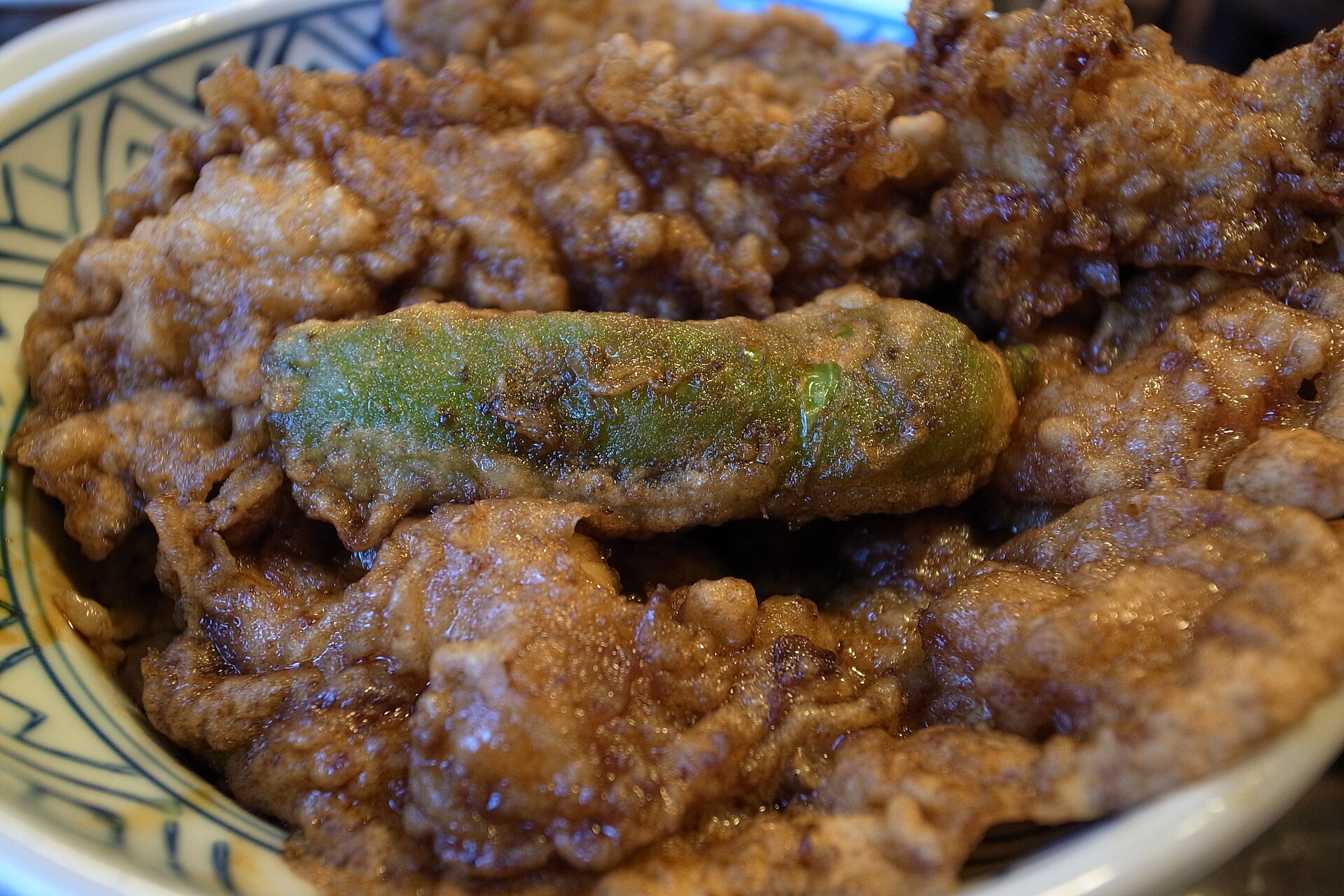 Close-up of a tendon bowl at Daikokuya in Asakusa, with prawn and vegetable tempura soaked in a dark sauce