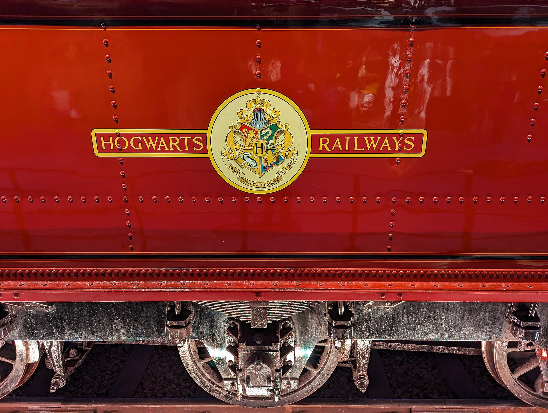 Close-up of the Hogwarts Railways crest painted on the red side of the Hogwarts Express locomotive